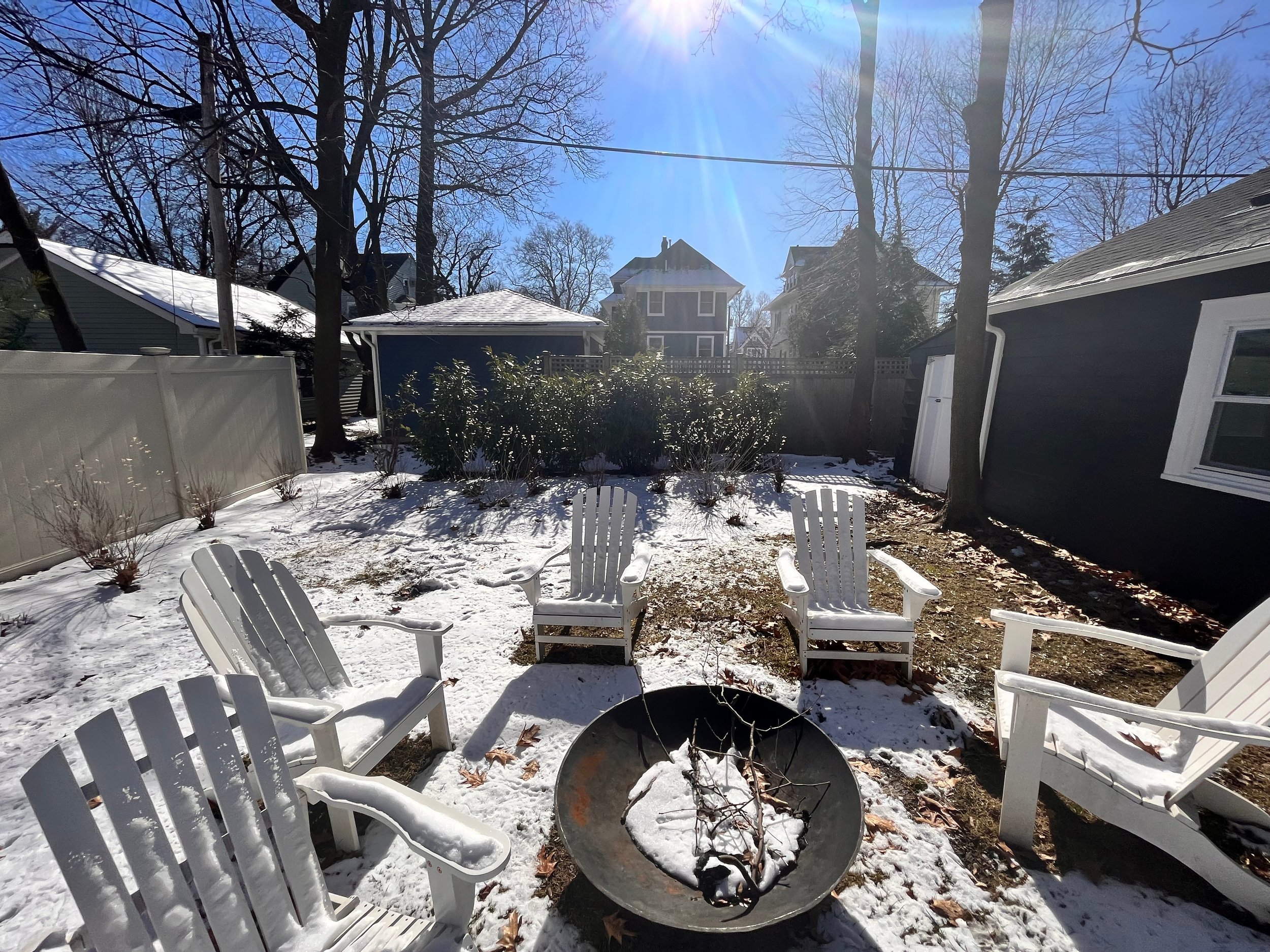 fire pit seating area directly on glass lawn with no hardscaped patio or privacy