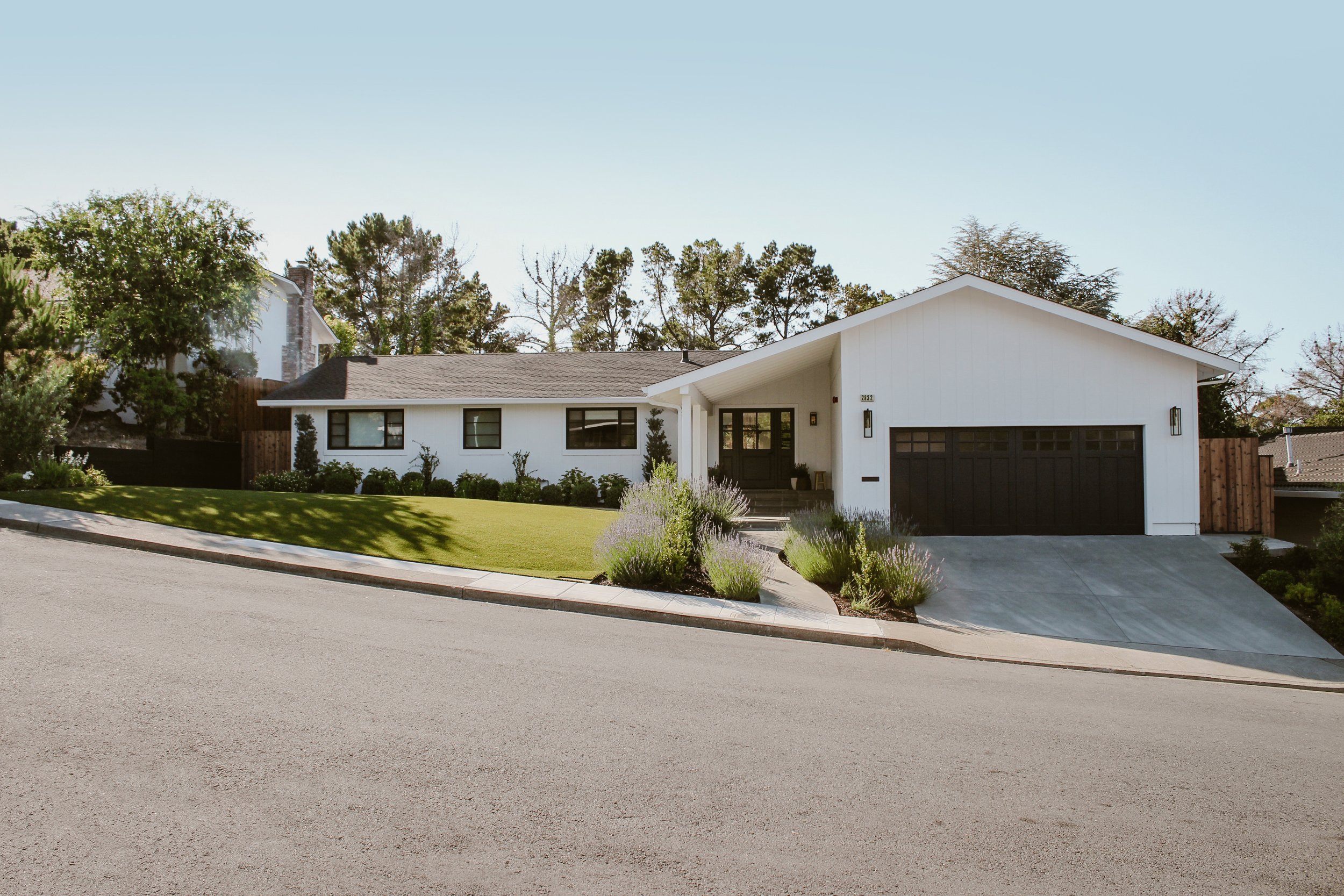 Full view from street of front of finished home and yard