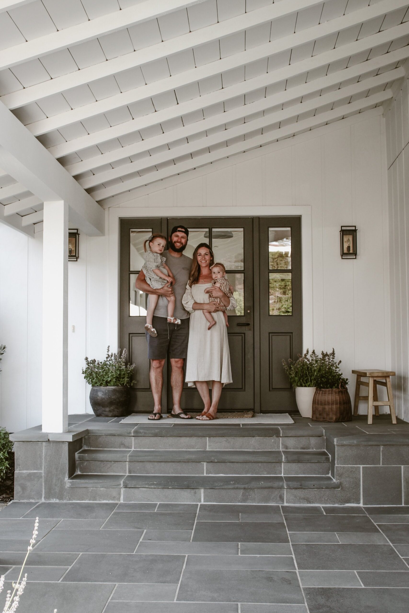 The whole family on the front porch of newly renovated home